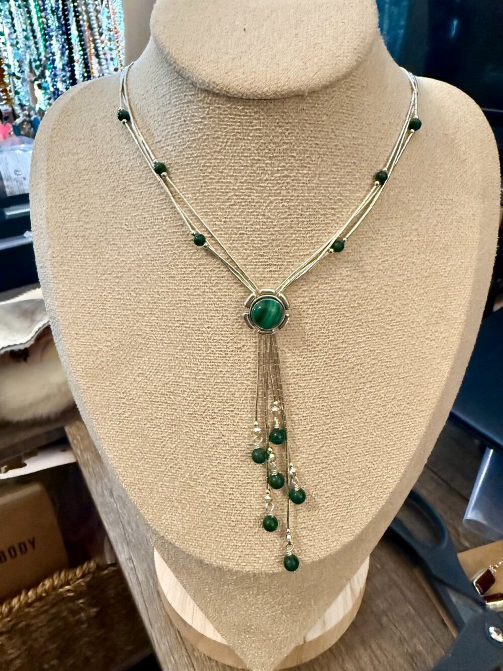 Liquid sterling silver necklace features a malachite cabochon pendant